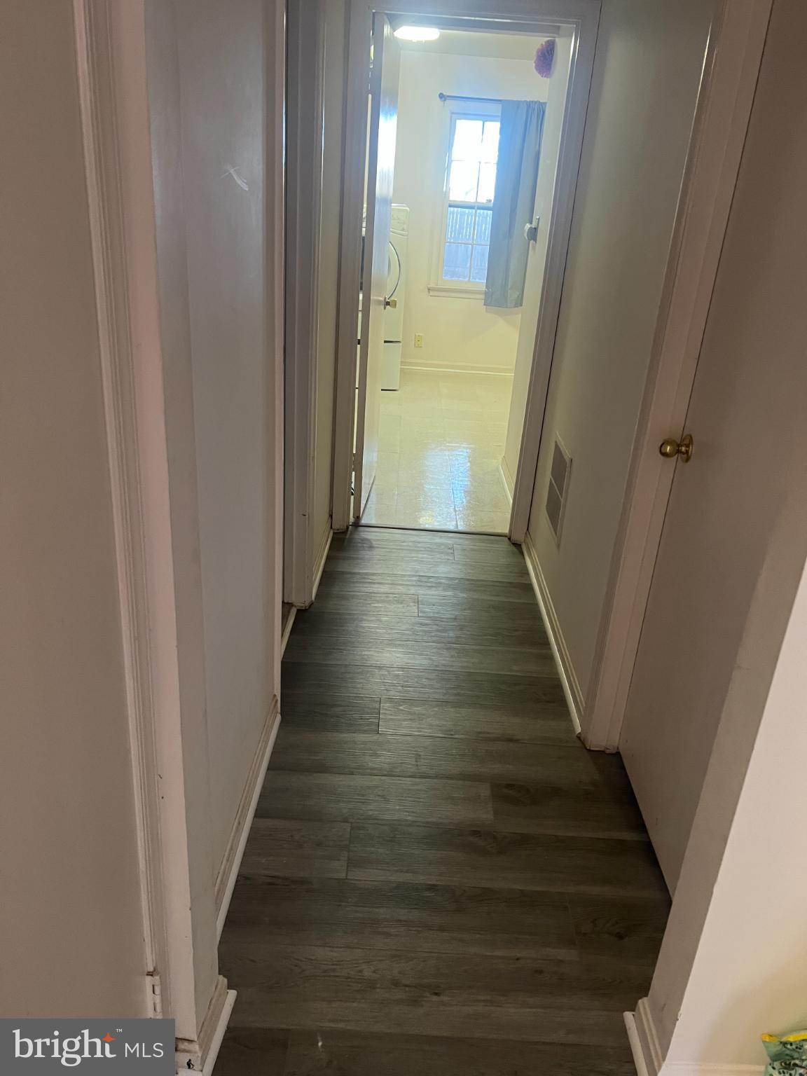 215 Summit Hall Road Gaithersburg, MD 20877 - Photo 2 of 20 a view of a hallway with wooden floor and staircase
