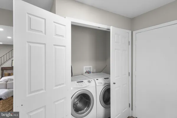 a view of storage and utility room with washer and dryer
