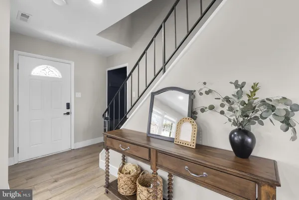 a view of entryway and hall with wooden floor
