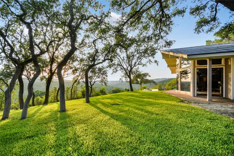 a view of an house with backyard space and garden