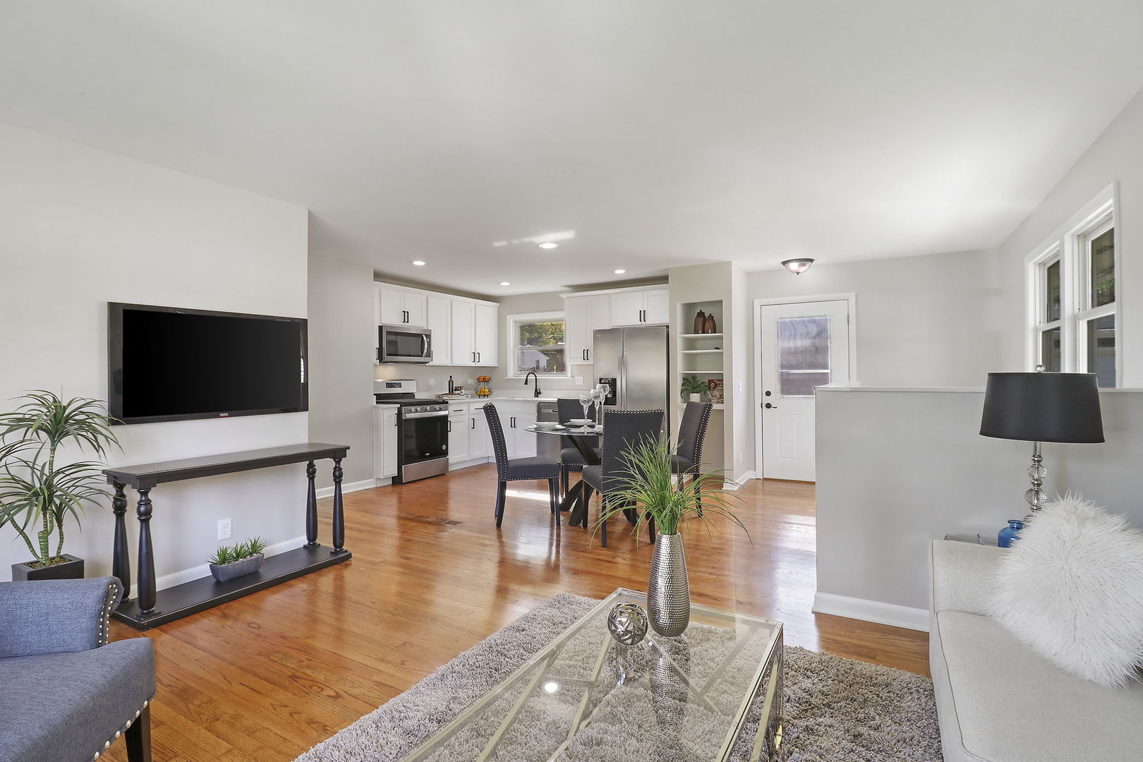 111 Wagner Drive Cary, IL 60013 - Photo 3 of 23 a living room with furniture a flat screen tv and a fireplace