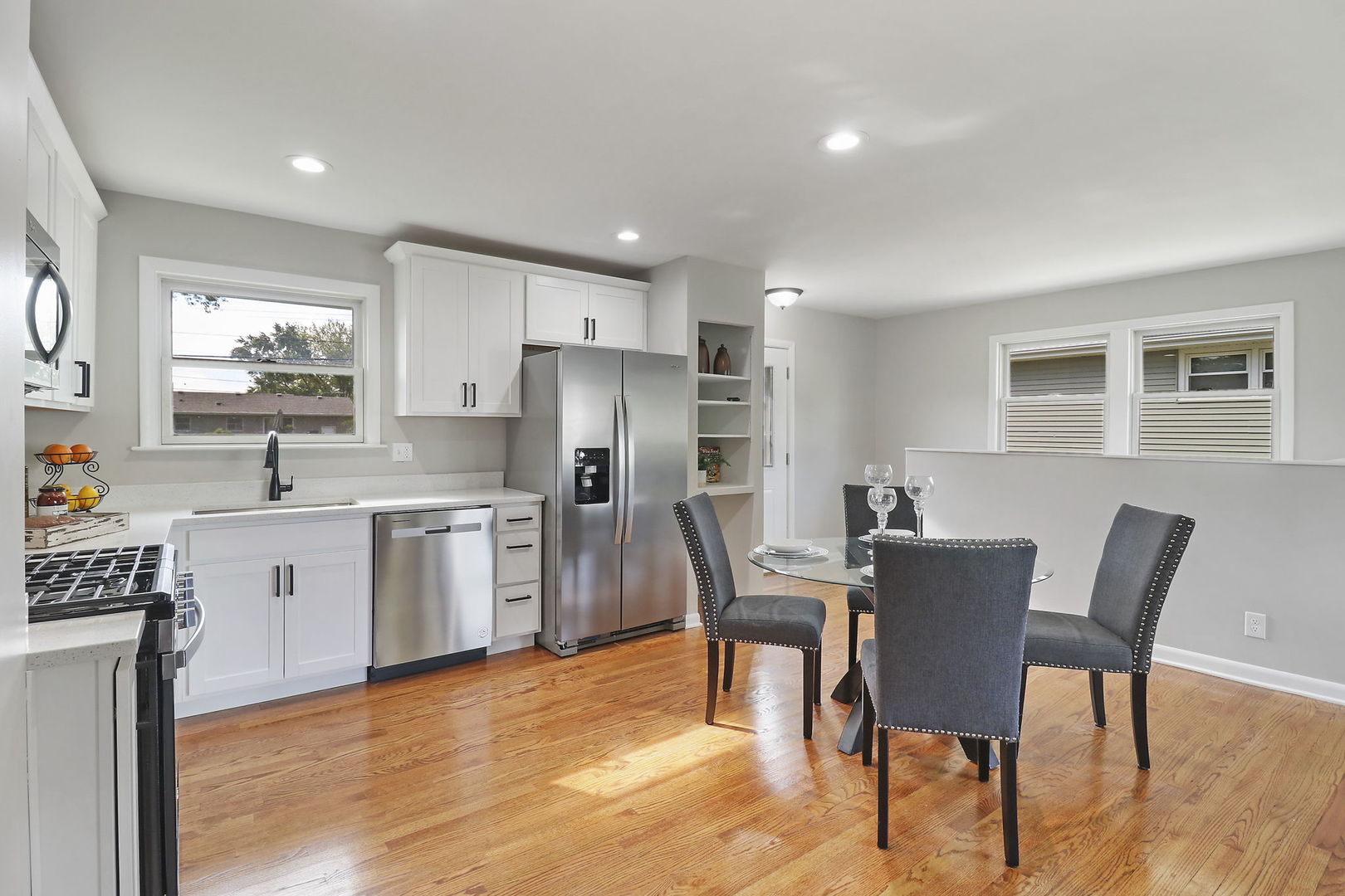 111 Wagner Drive Cary, IL 60013 - Photo 7 of 23 a view of kitchen with refrigerator stove dining table and chairs
