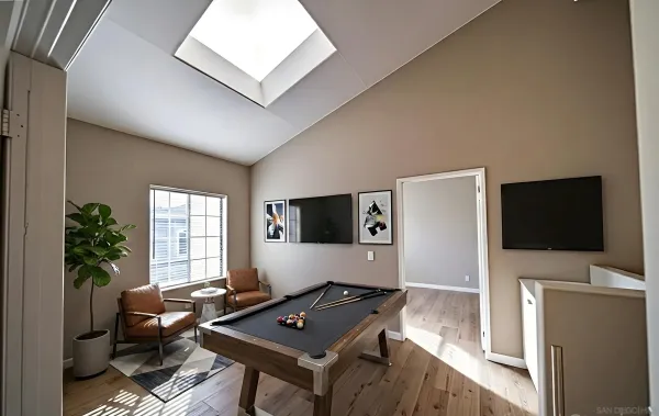 a living room with furniture a window and a potted plant