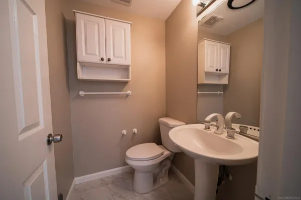 a kitchen with white cabinets stainless steel appliances and sink