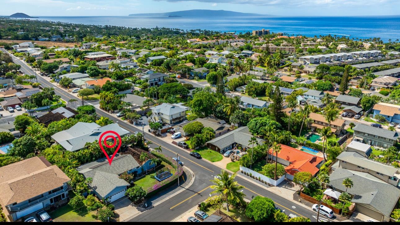 an aerial view of residential houses with outdoor space and street view