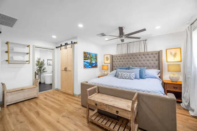 a bedroom with a bed and a chandelier