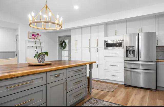 a kitchen with granite countertop a stove and a refrigerator