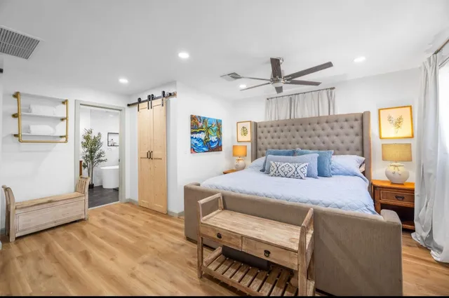 a view of a patio with couches table and chairs and potted plants