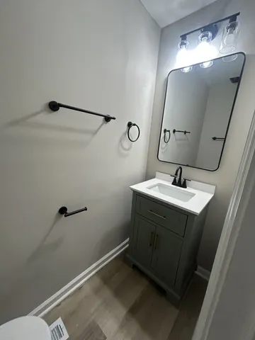 a bathroom with a sink vanity and mirror
