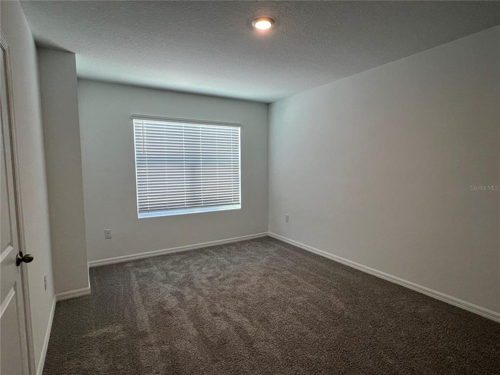 2472 Riversong Ldg Lane Wesley Chapel, FL 33543 - Photo 12 of 24 an empty room with windows