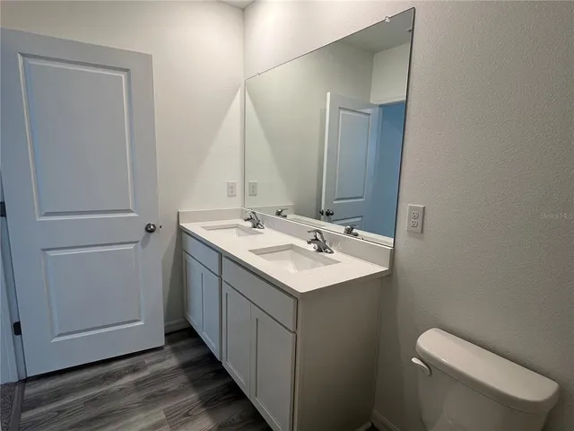 a bathroom with a sink toilet and mirror
