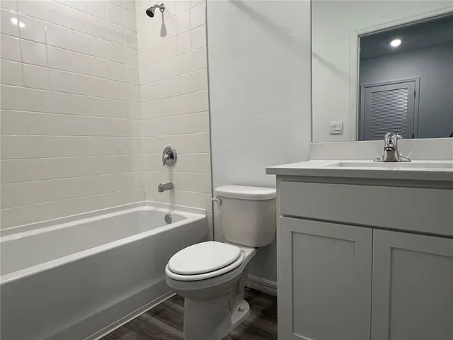 a bathroom with a sink a toilet and bathtub