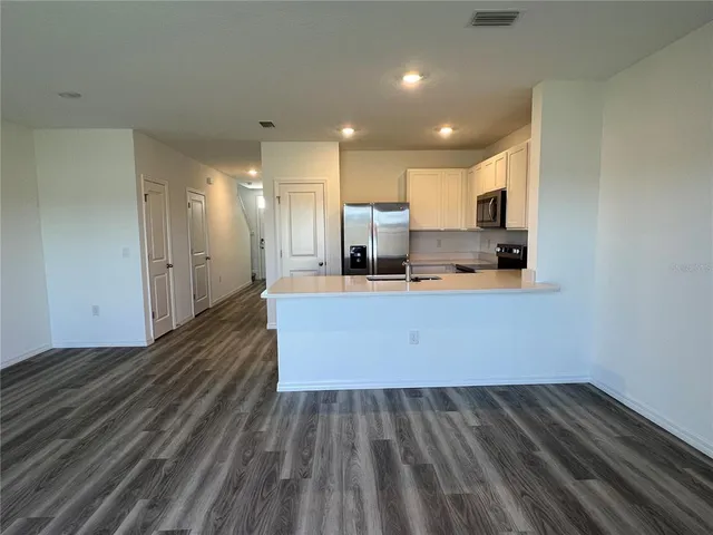 a view of kitchen with wooden floor
