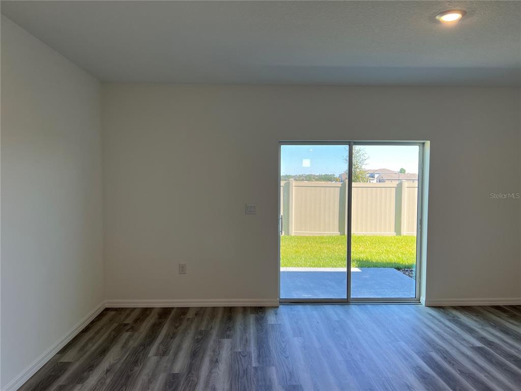 2472 Riversong Ldg Lane Wesley Chapel, FL 33543 - Photo 8 of 24 a view of room with window and wooden floor