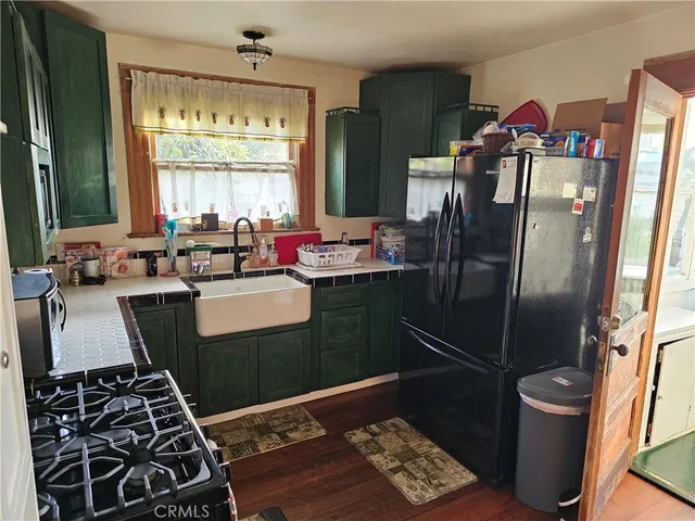 a kitchen with a sink stove and refrigerator