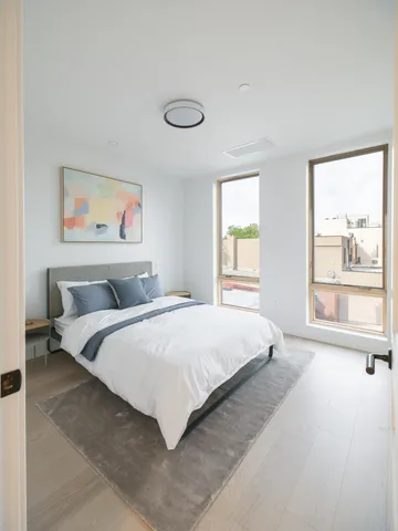 a bathroom with a double vanity sink toilet and shower