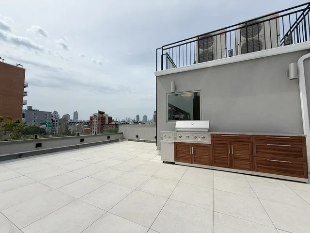 a view of a kitchen with a sink and a stove top oven