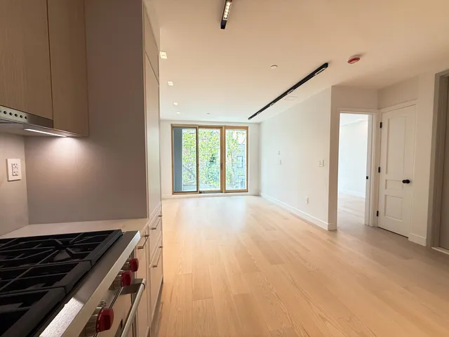 a kitchen with stainless steel appliances a stove and cabinets