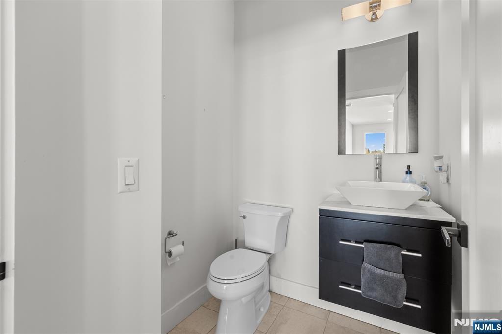 7 Oakdene Terrace, Unit 7 Edgewater, NJ 07020 - Photo 17 of 30 a bathroom with a sink toilet and mirror