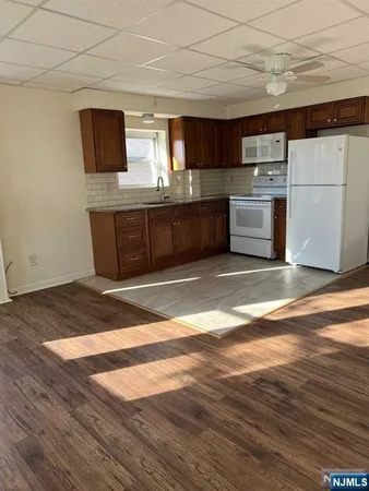 a kitchen with stainless steel appliances granite countertop a stove a microwave and a refrigerator