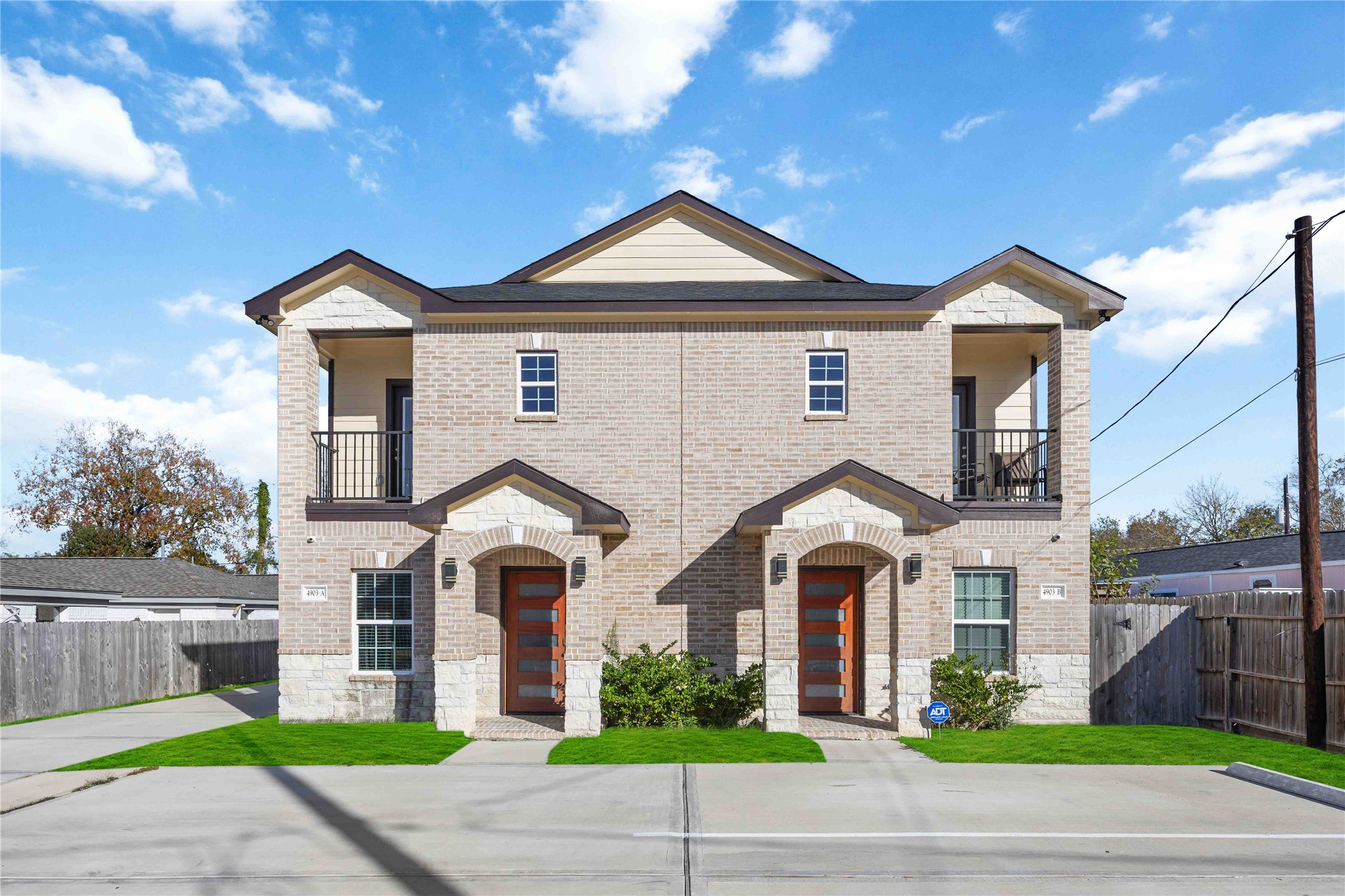4903 Mallow Street, Unit A Houston, TX 77033 - Photo 1 of 10 Exterior combines light- colored tan brick with white stone accents and arched entryways.