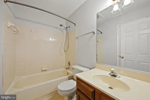 a bathroom with a sink toilet tub and shower