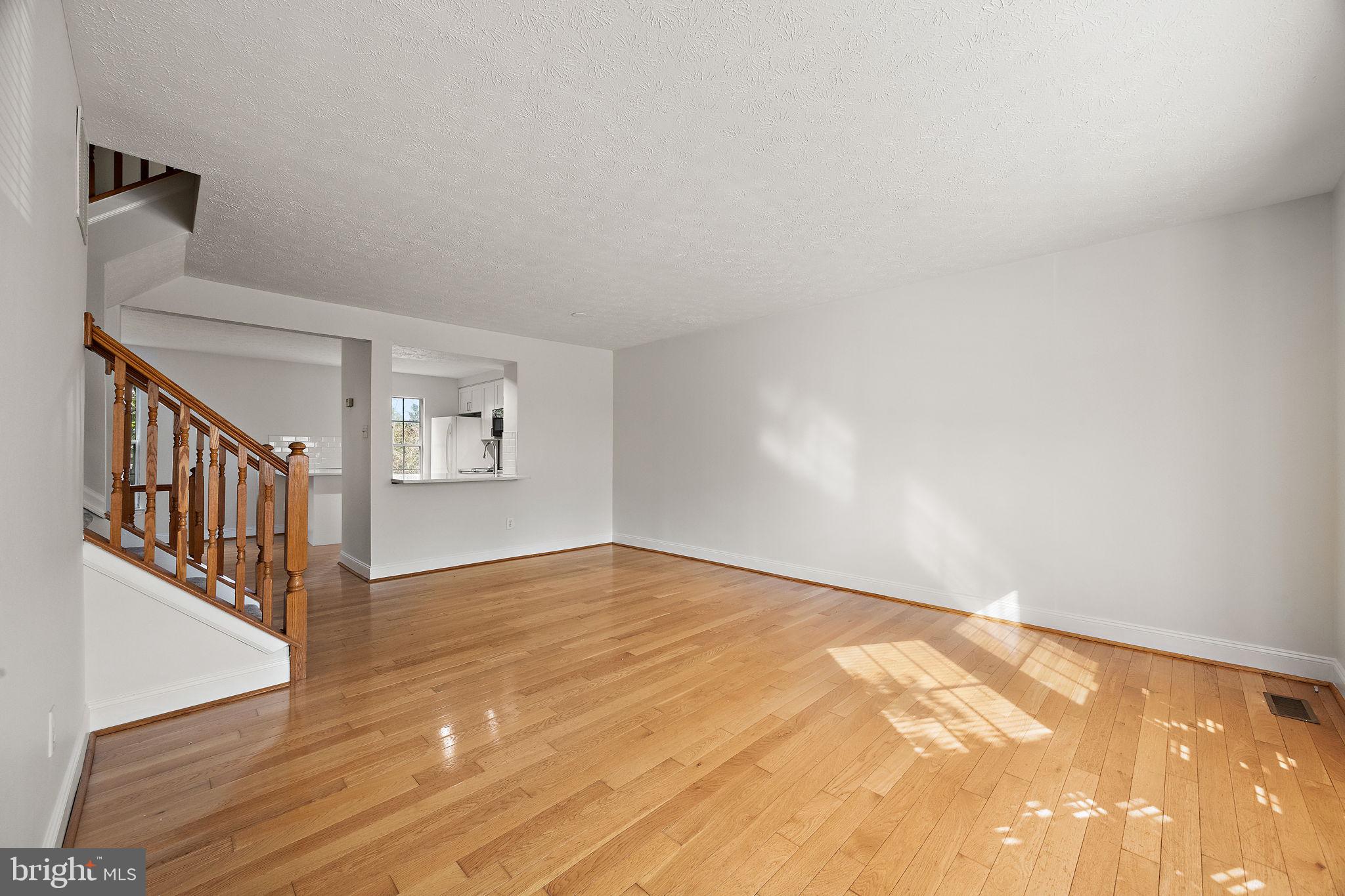 104 West Shetland Court Newark, DE 19711 - Photo 3 of 22 a view of an empty room with wooden floor and a window