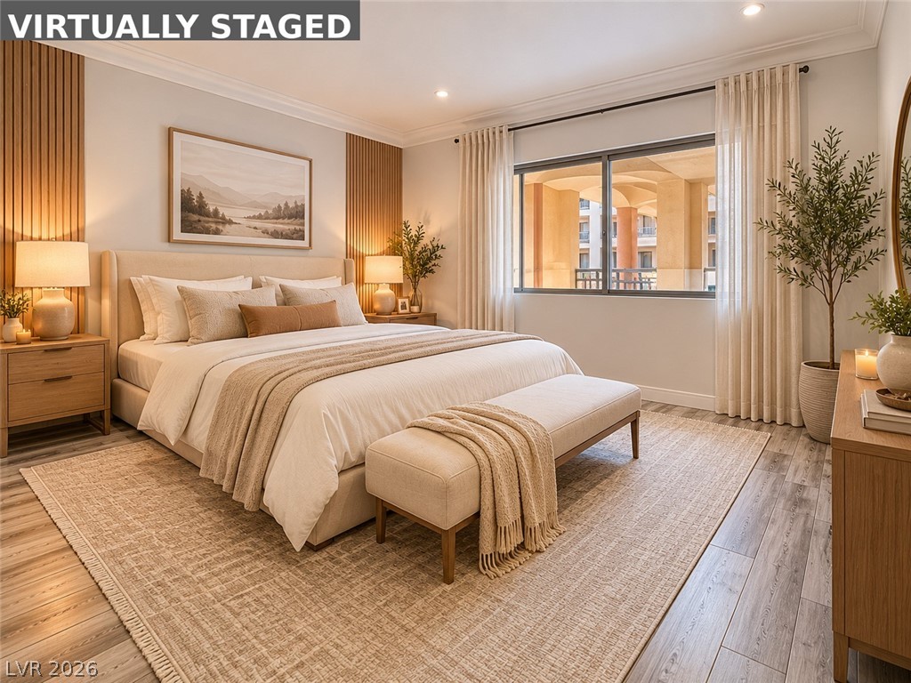 260 East Flamingo Road, Unit 220 Las Vegas, NV 89169 - Photo 32 of 32 Indulge in peaceful slumber within this generously proportioned bedroom featuring wood-look flooring and crown molding.