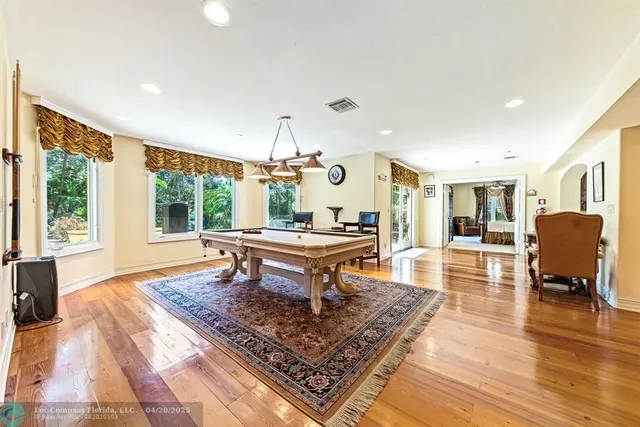 a living room with furniture a rug and a floor to ceiling window