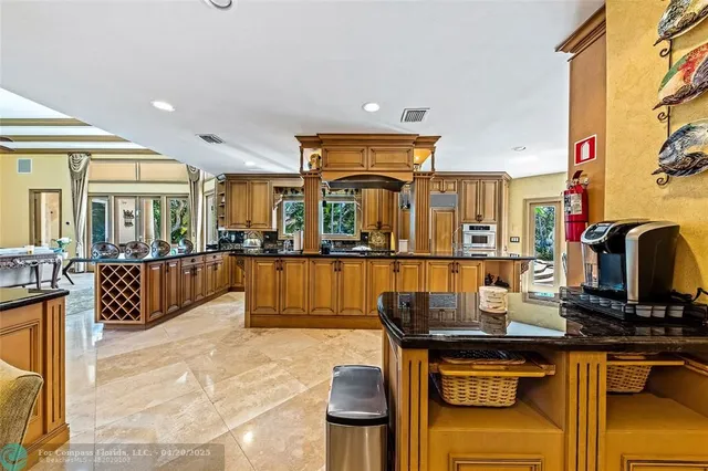 a living room with furniture a flat screen tv and kitchen view