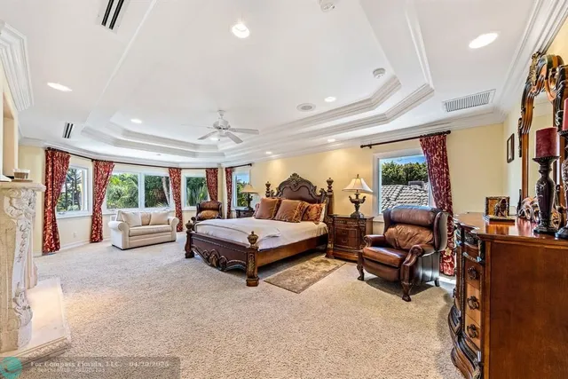 a bedroom with furniture and large windows