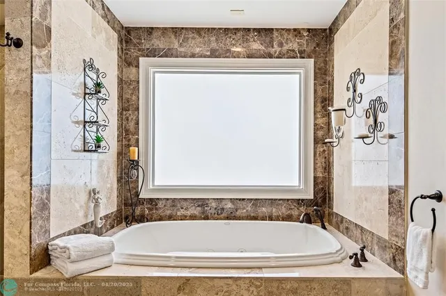 a bathroom with a tub and shower