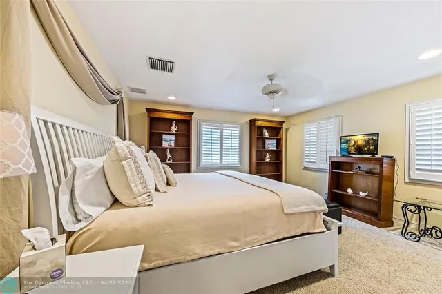 a bedroom with a bed and dresser with mirror