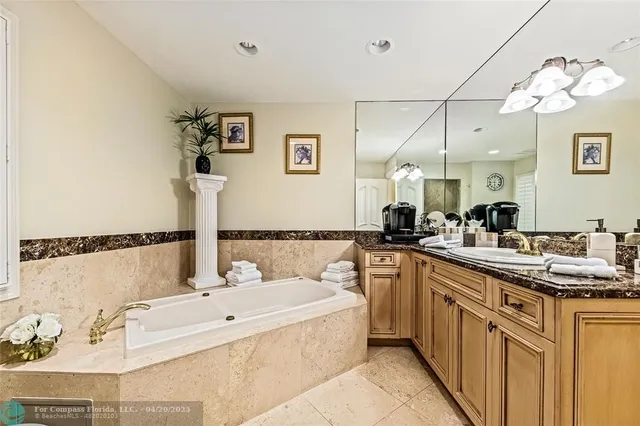 a bathroom with a tub sink and mirror