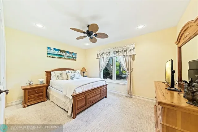 a spacious bedroom with a bed and a flat screen tv