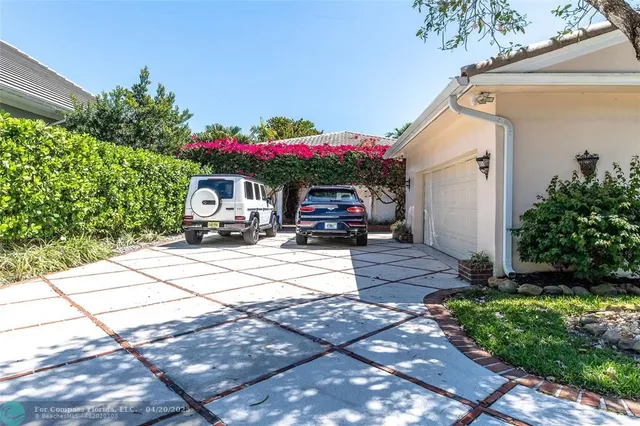 a front view of a house with a yard and a garage