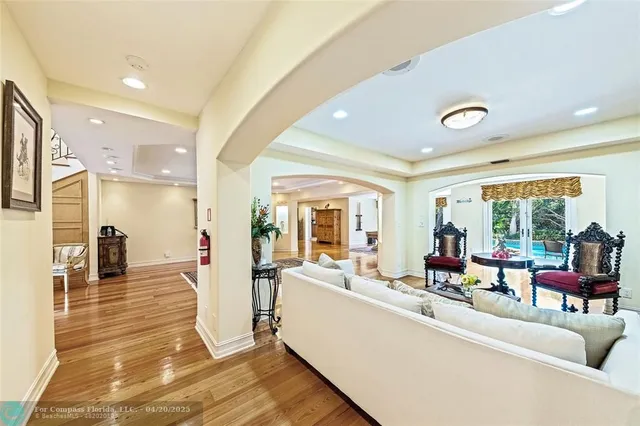 a living room with furniture and large windows