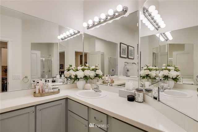 a bathroom with a sink double vanity and a mirror