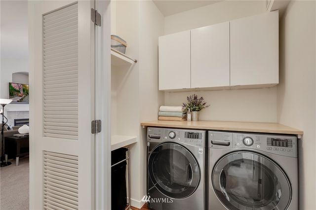 a view of a hallway with washer and dryer