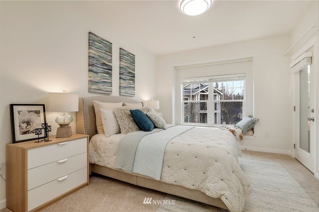 a bedroom with a large bed and a window