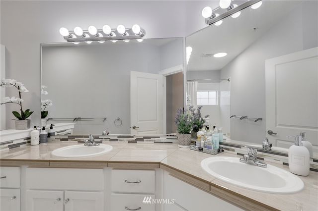 a bathroom with a sink double vanity and a mirror