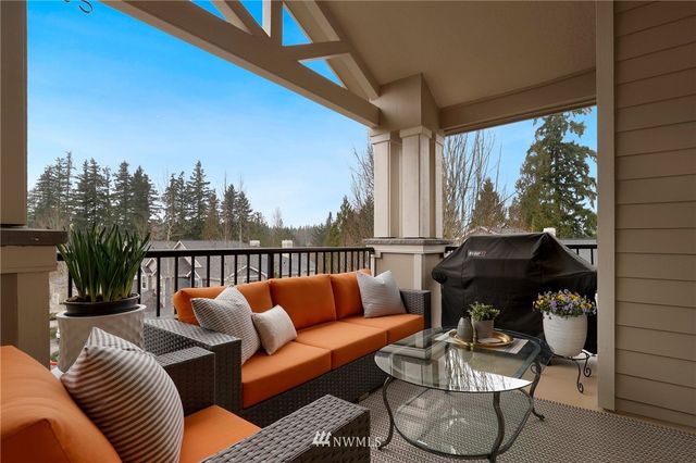 a balcony with furniture and a potted plant