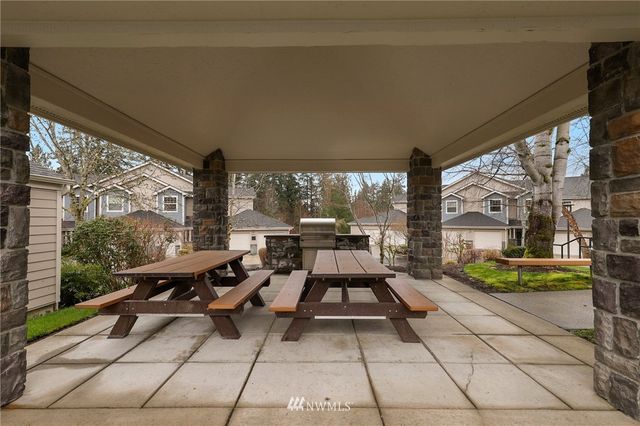 a living room with patio furniture and a floor to ceiling window