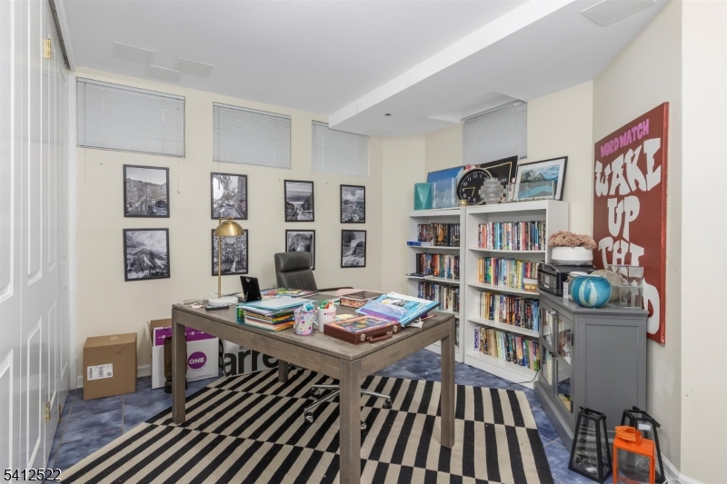 6 Harding Court Passaic, NJ 07055 - Photo 16 of 17 a living room with furniture and a book shelf