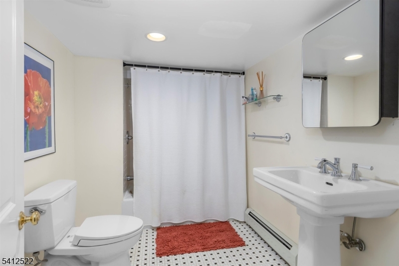 6 Harding Court Passaic, NJ 07055 - Photo 17 of 17 a bathroom with a sink a toilet and shower