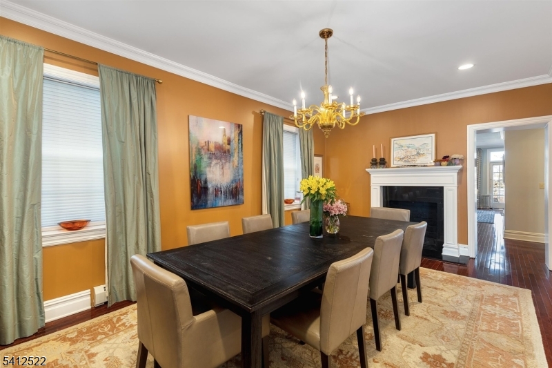 6 Harding Court Passaic, NJ 07055 - Photo 5 of 17 a dining room with furniture a chandelier and wooden floor