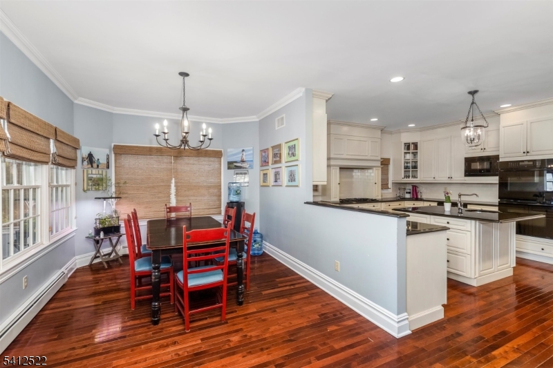 6 Harding Court Passaic, NJ 07055 - Photo 7 of 17 a kitchen with stainless steel appliances kitchen island granite countertop a table chairs and a refrigerator