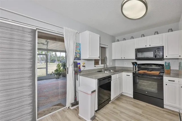 a kitchen with a stove a sink and a refrigerator