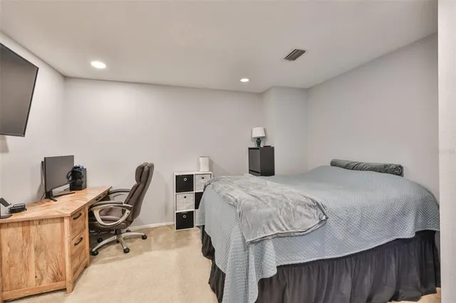 a bedroom with a bed and a desk