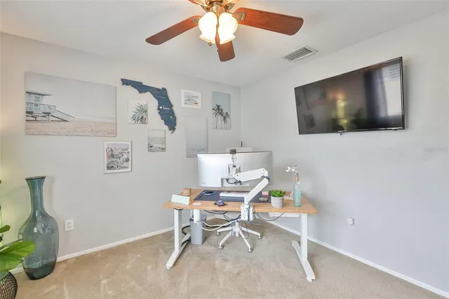 a workspace with furniture and a flat screen tv